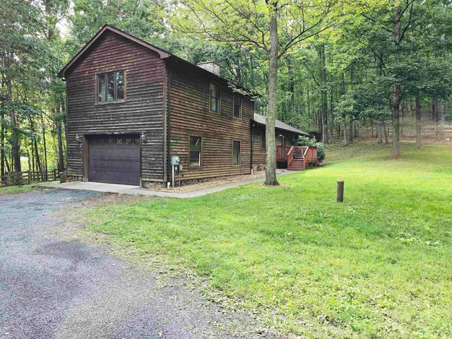a view of backyard of house with green space