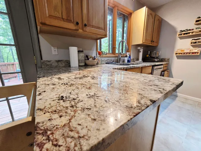 a kitchen with a sink a stove a microwave a sink and a refrigerator