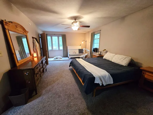 a bedroom with a large bed and a chandelier