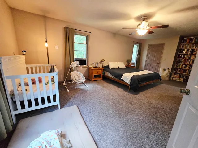 a bedroom with furniture and a chandelier