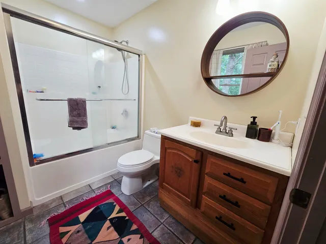 a bathroom with a toilet a sink and a mirror