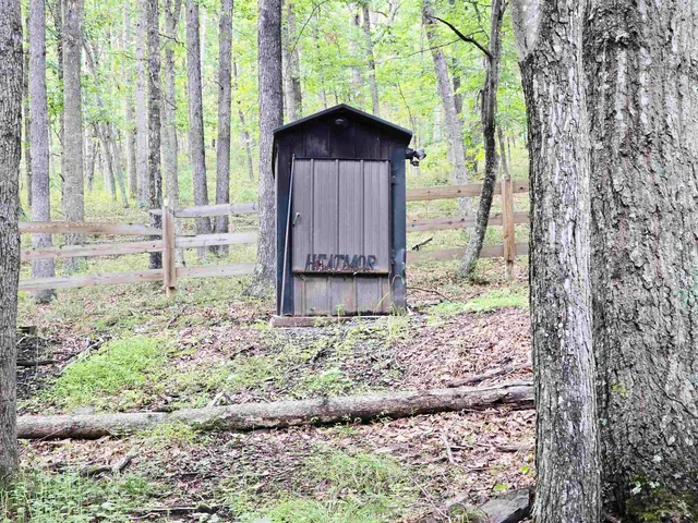 a view of a wooden fence next to a large tree