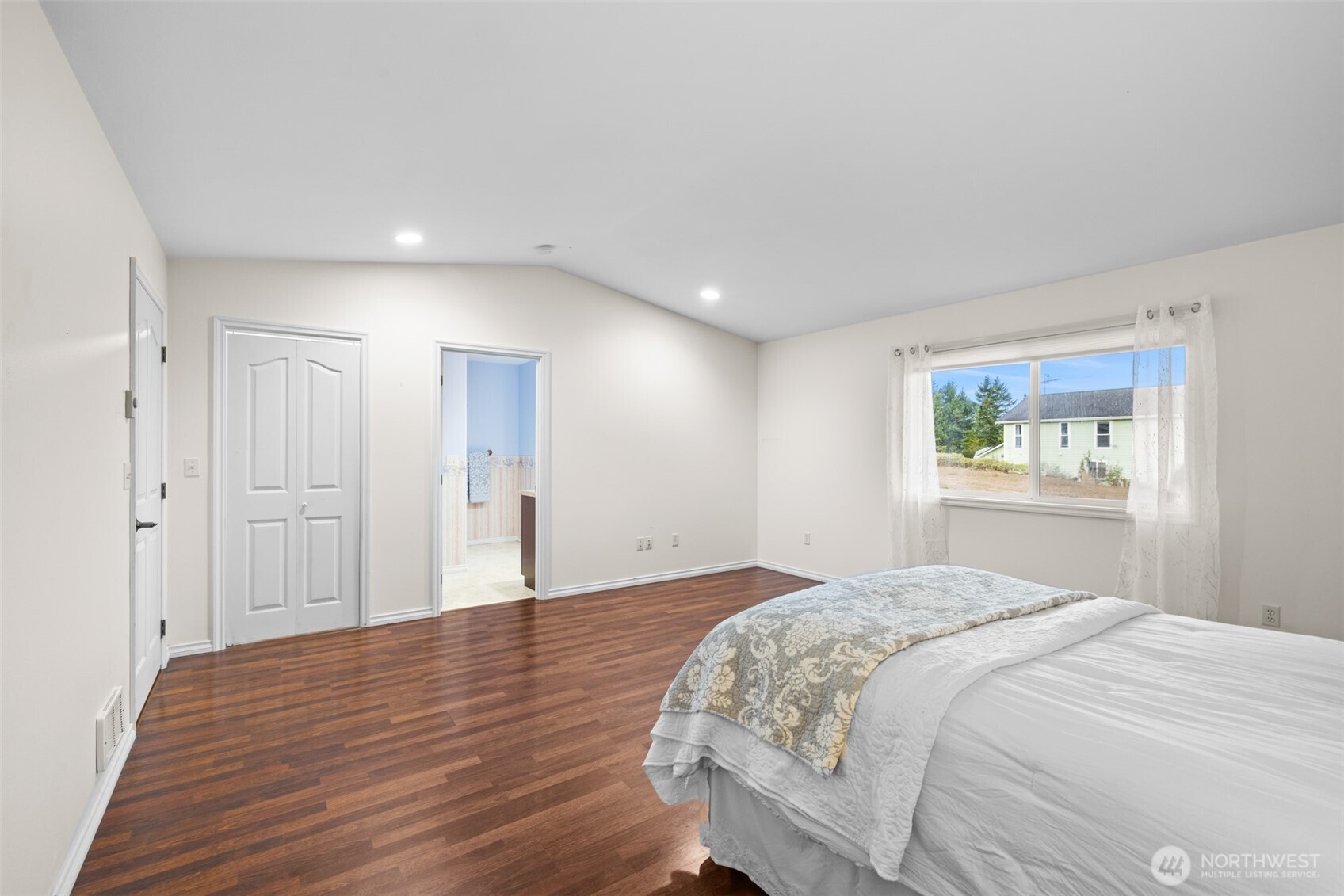 382 Discovery View Drive Sequim, WA 98382 - Photo 15 of 40 a bedroom with a bed and a painting on the wall