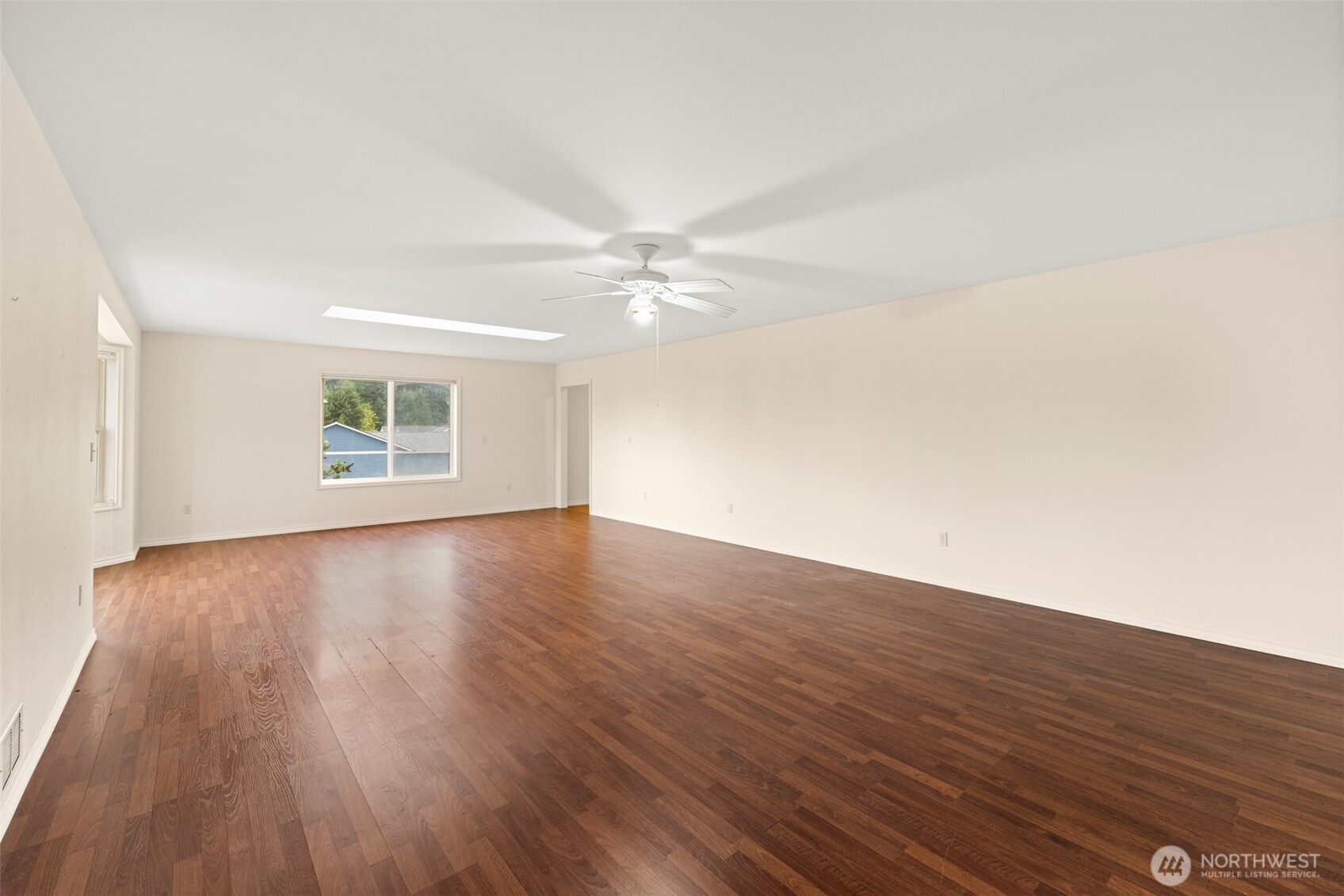 382 Discovery View Drive Sequim, WA 98382 - Photo 22 of 40 an empty room with wooden floor and windows