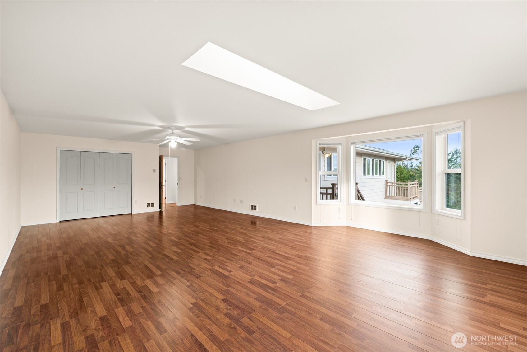 382 Discovery View Drive Sequim, WA 98382 - Photo 23 of 40 a view of an empty room with wooden floor and a window