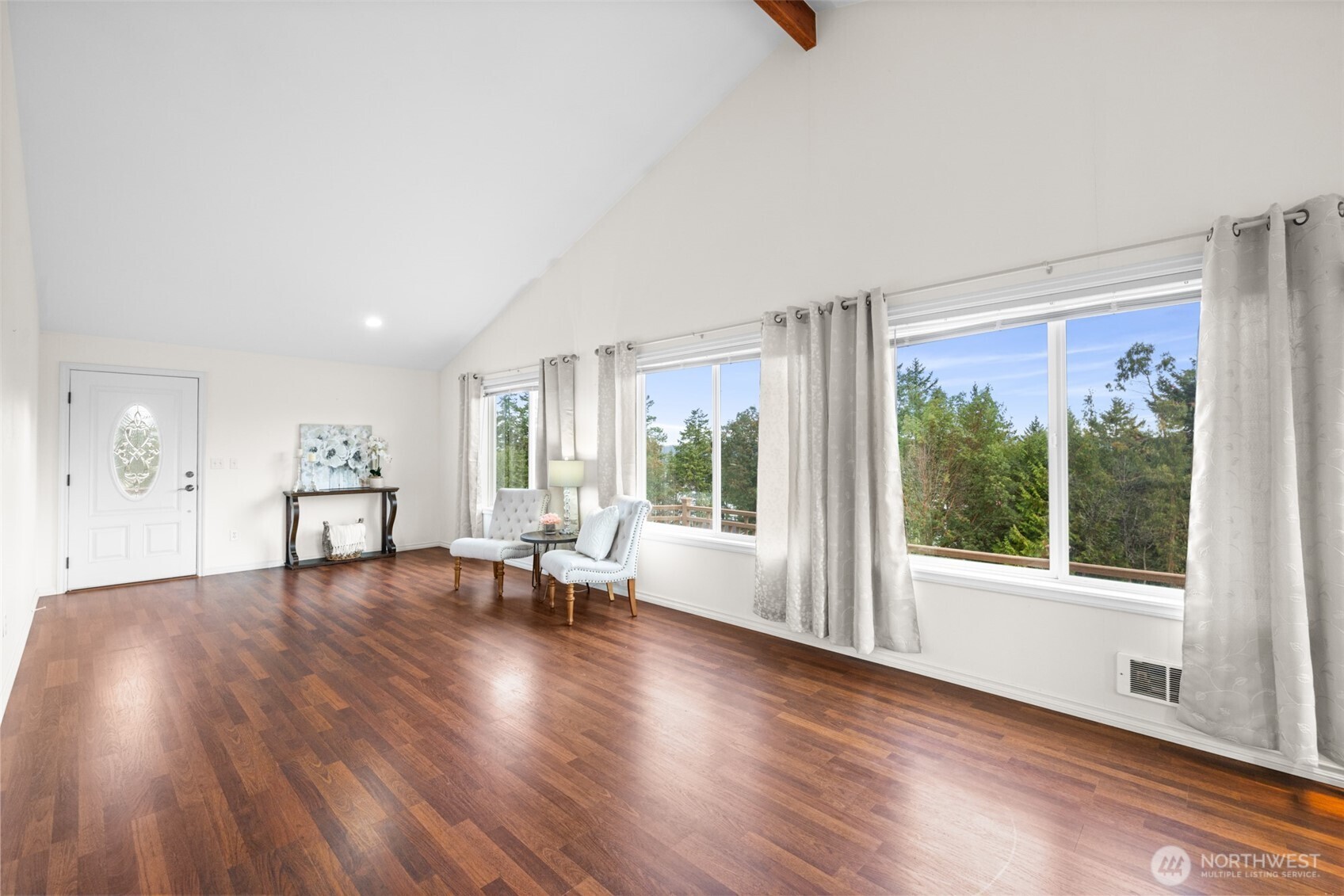 382 Discovery View Drive Sequim, WA 98382 - Photo 7 of 40 a view of an empty room with wooden floor and a window