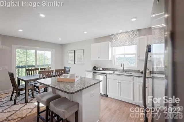 a kitchen with granite countertop sink dining table and chairs