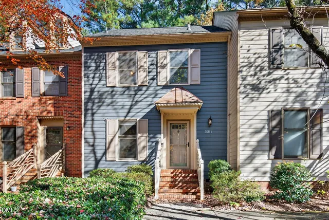 a front view of a house with a garden