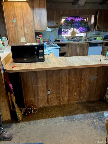 a room with stainless steel appliances kitchen island granite countertop a sink and a stove