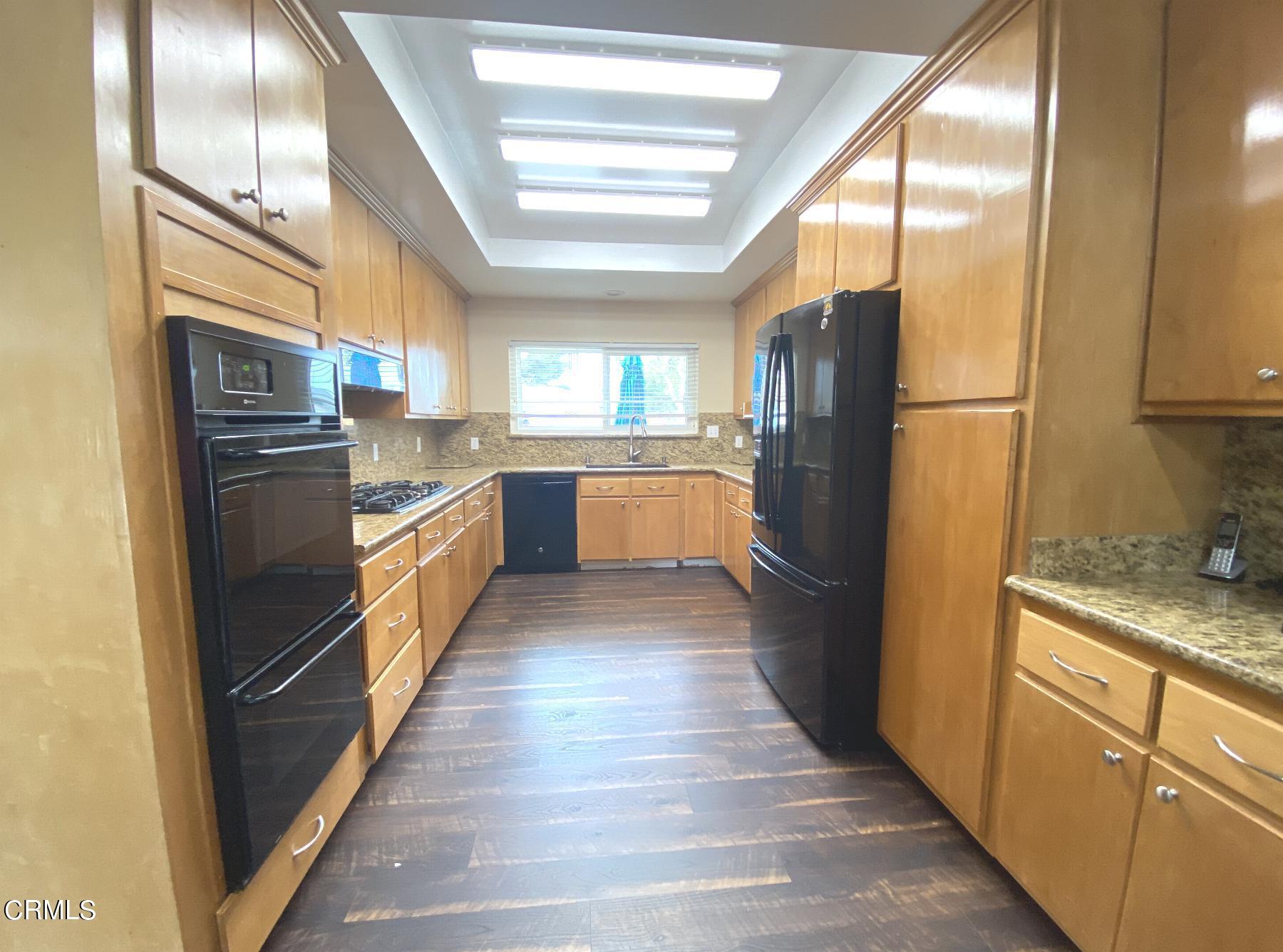 4520 Reeder Avenue Oxnard, CA 93033 - Photo 11 of 28 a kitchen with granite countertop stainless steel appliances a refrigerator counter tops and a stove