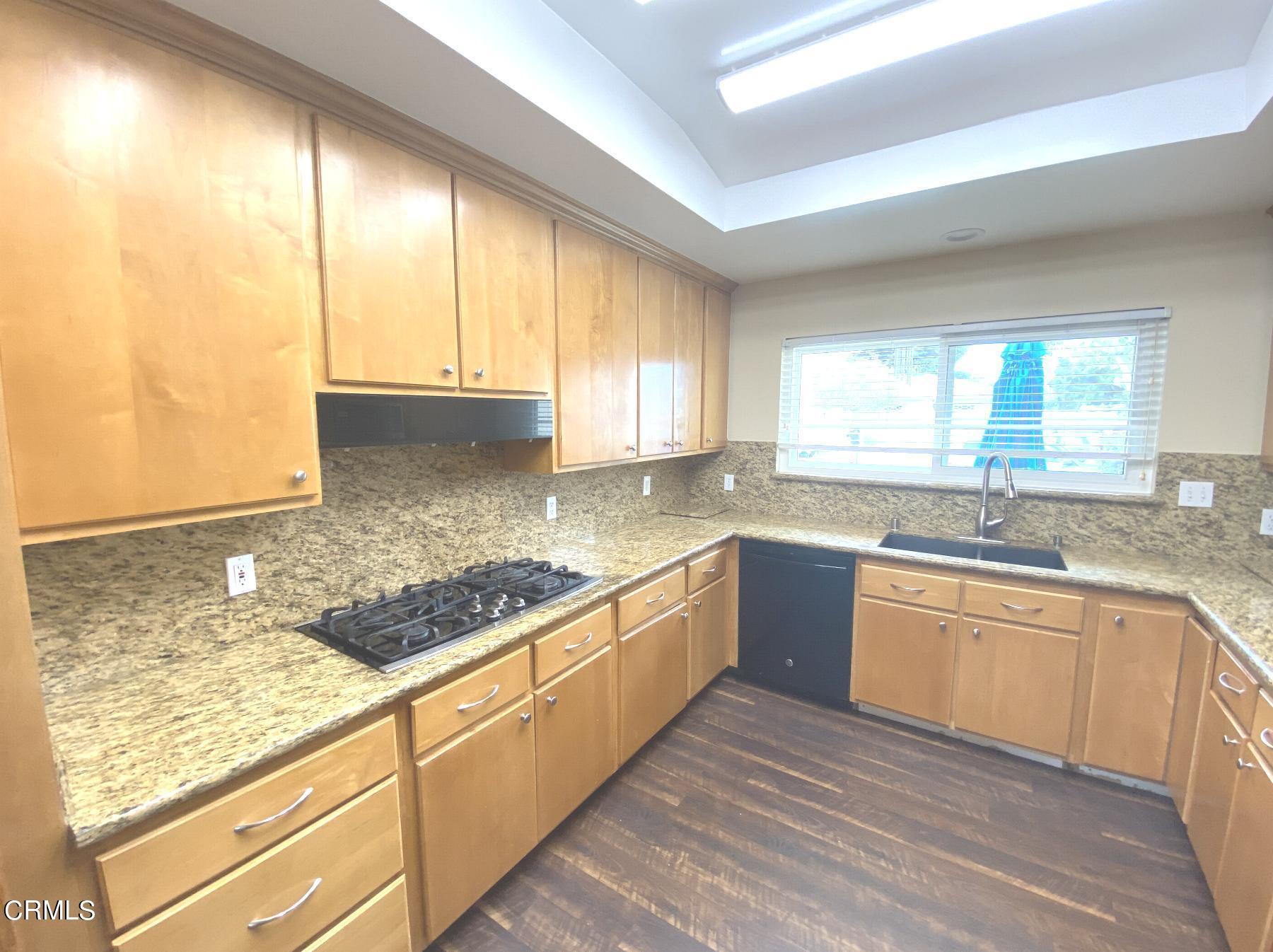 4520 Reeder Avenue Oxnard, CA 93033 - Photo 12 of 28 a kitchen with stainless steel appliances granite countertop a sink and cabinets