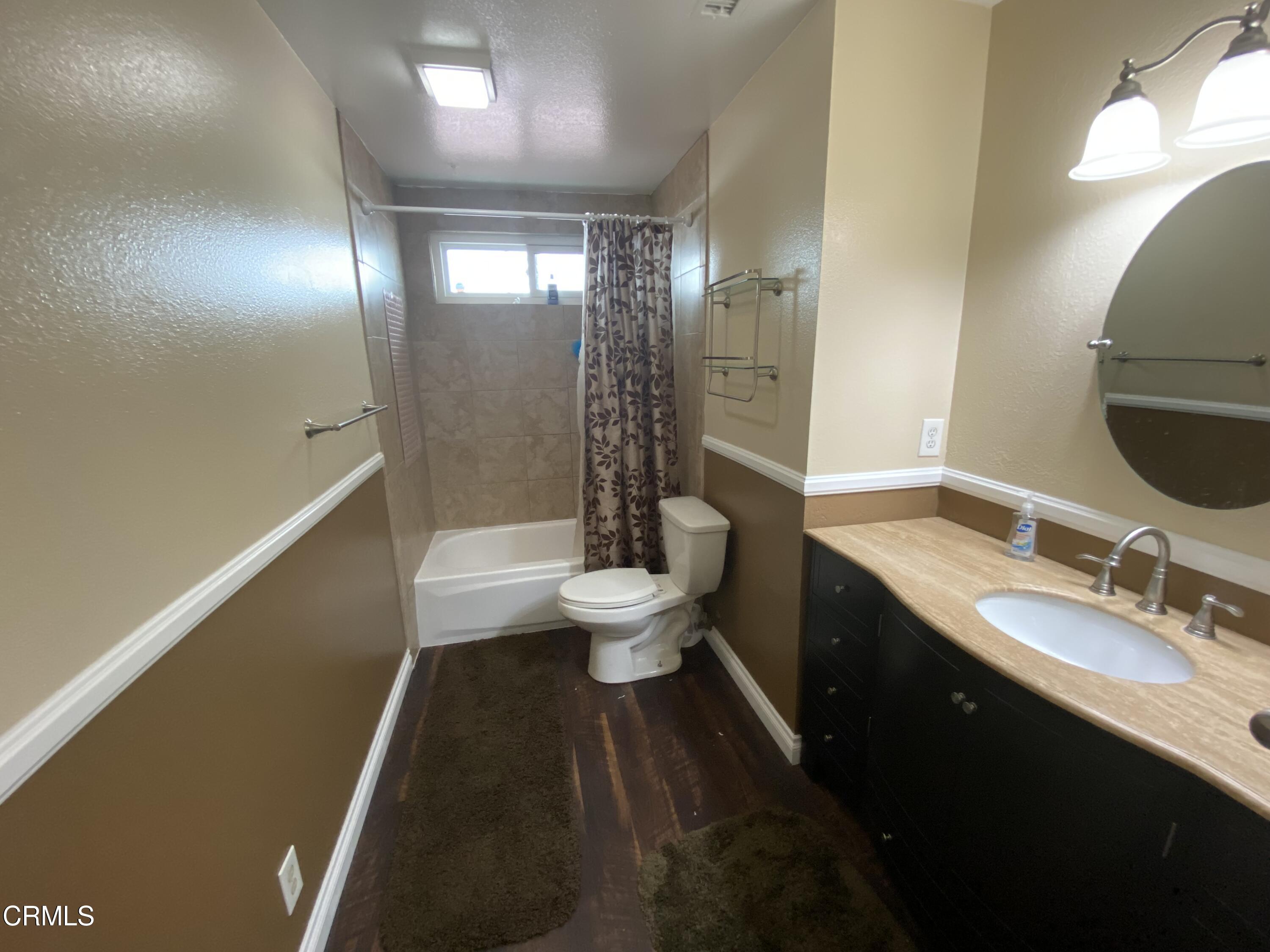 4520 Reeder Avenue Oxnard, CA 93033 - Photo 16 of 28 a bathroom with a double vanity sink toilet and shower