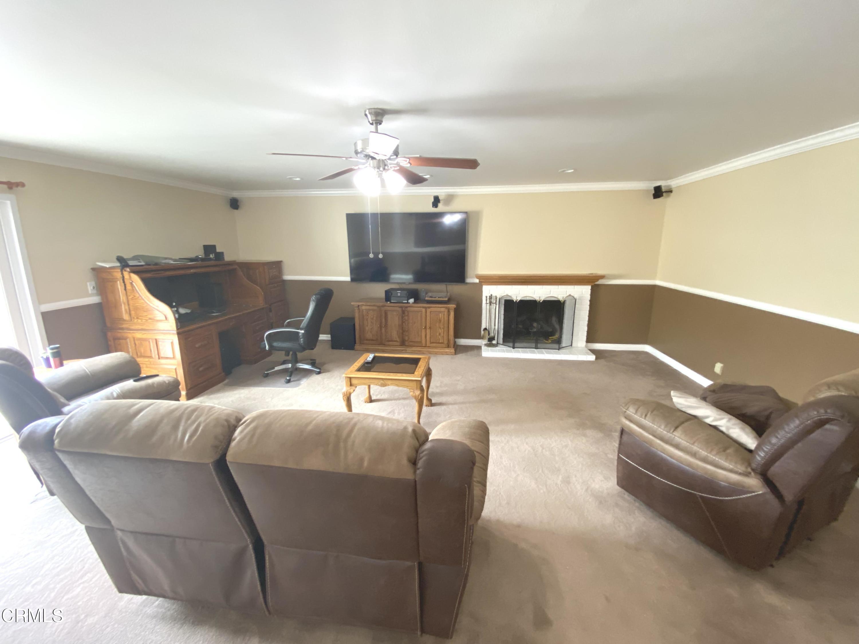 4520 Reeder Avenue Oxnard, CA 93033 - Photo 3 of 28 a living room with furniture and a fireplace