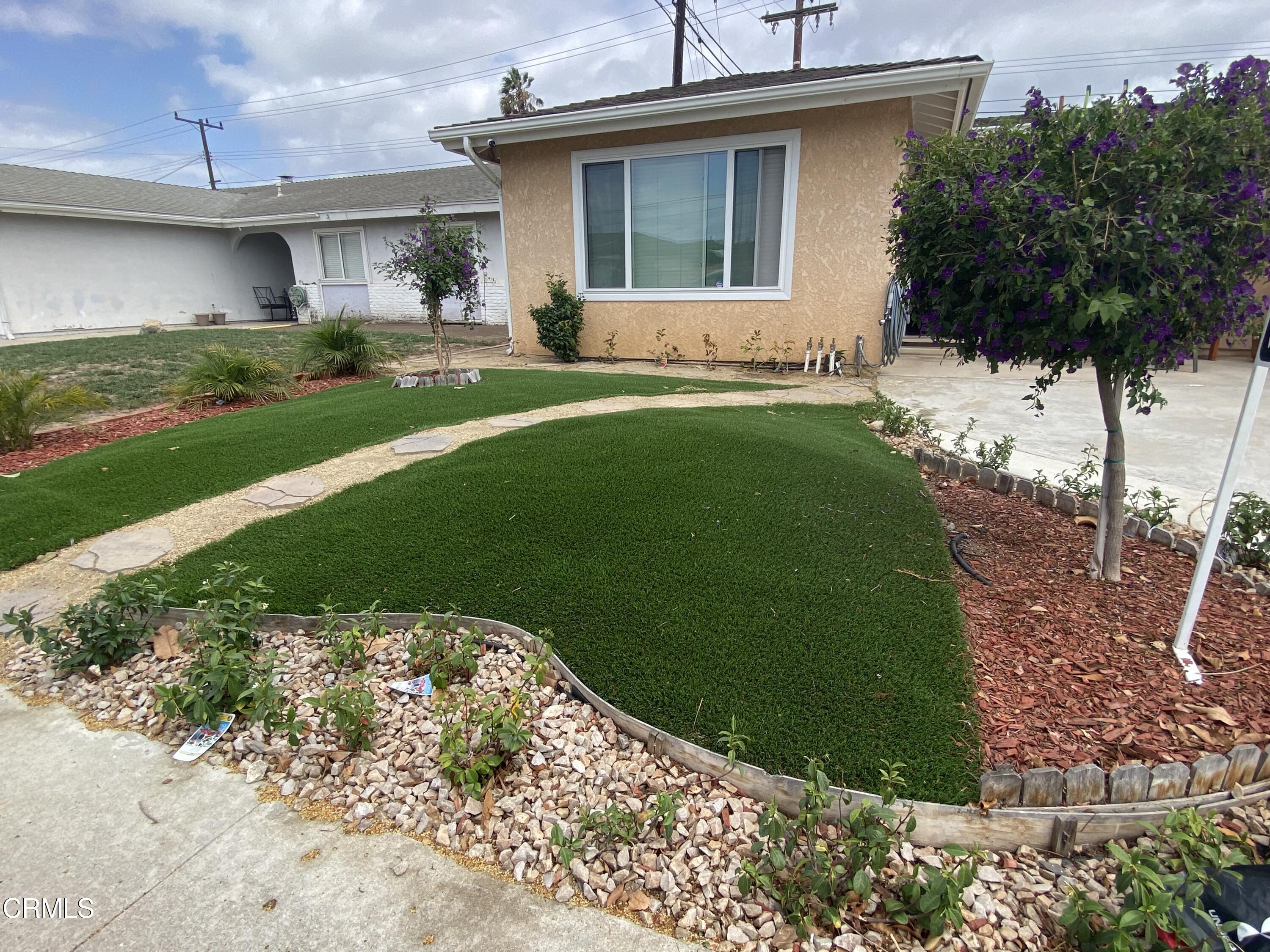 4520 Reeder Avenue Oxnard, CA 93033 - Photo 27 of 28 a front view of a house with a yard and garage