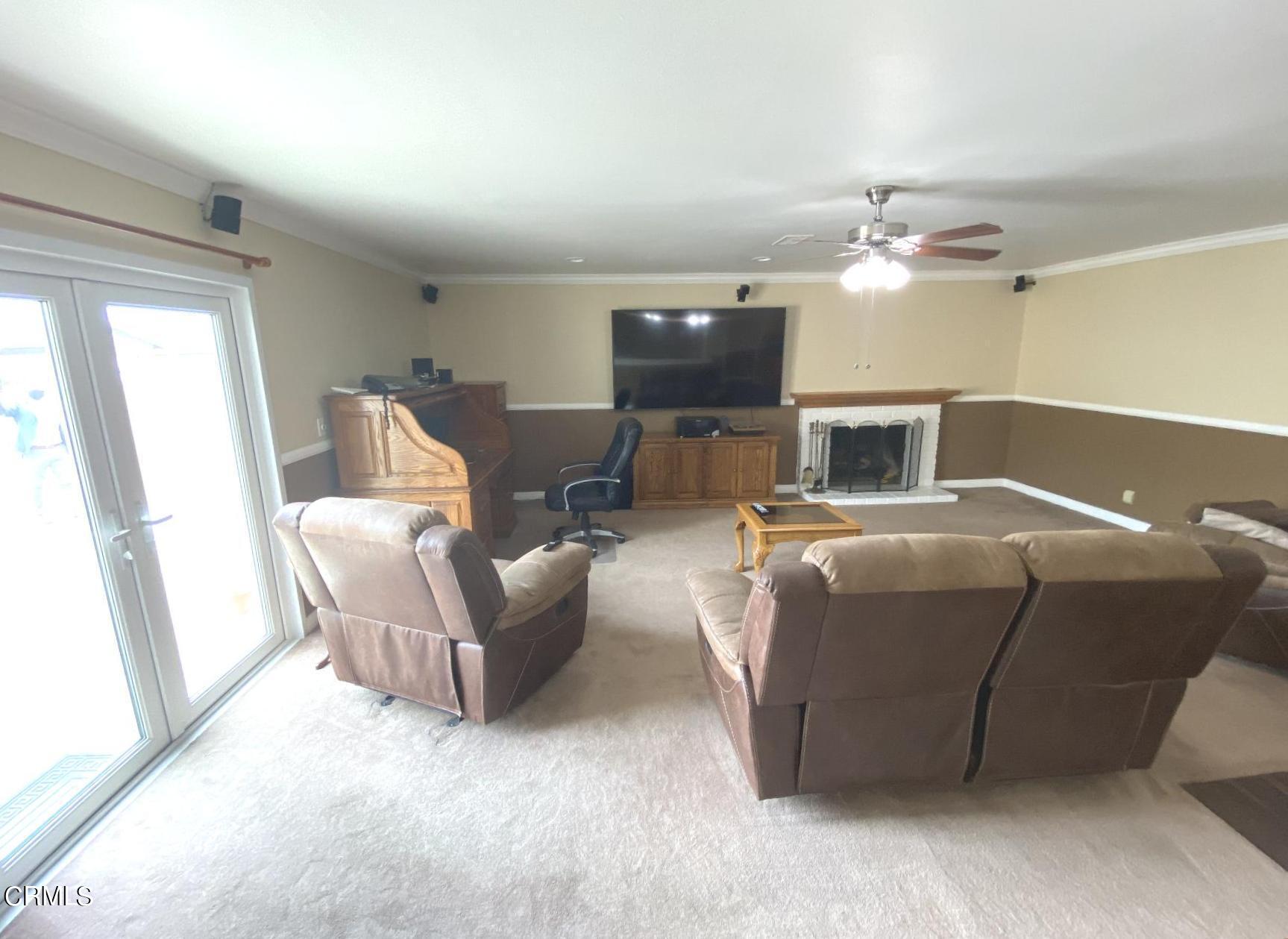 4520 Reeder Avenue Oxnard, CA 93033 - Photo 5 of 28 a living room with furniture and a flat screen tv