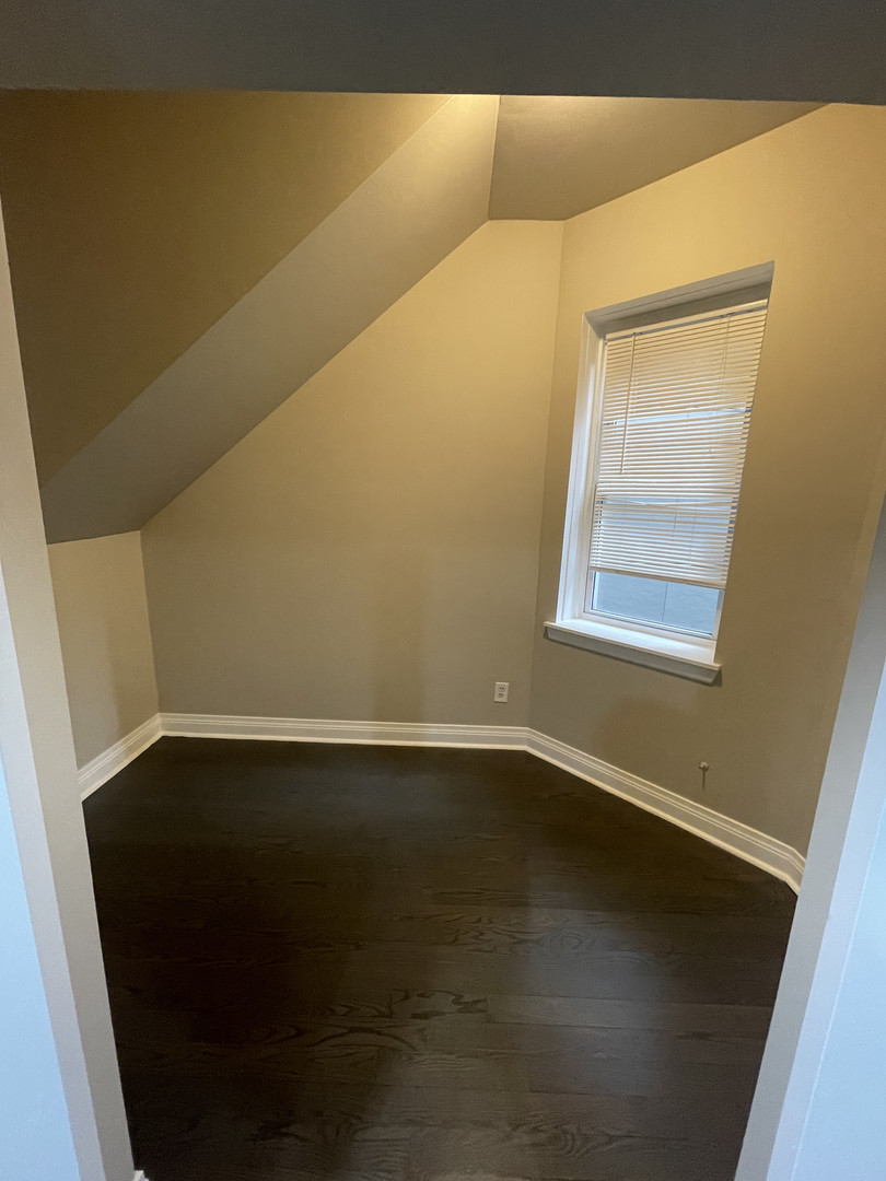2826 West Lyndale Street, Unit 1 Chicago, IL 60647 - Photo 16 of 20 a view of an empty room with wooden floor and a window