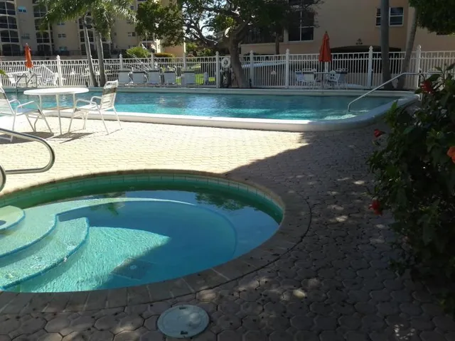 a view of a swimming pool with a yard