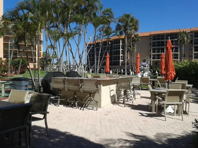 a view of a patio with table and chairs and potted plants