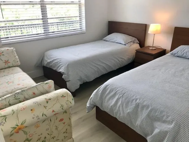 a bedroom with two beds and a window