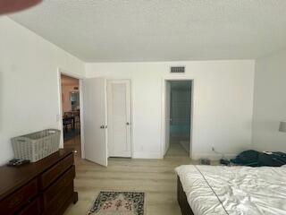2871 North Ocean Boulevard, Unit V457 Boca Raton, FL 33431 - Photo 35 of 42 a bedroom with a bed and a dresser