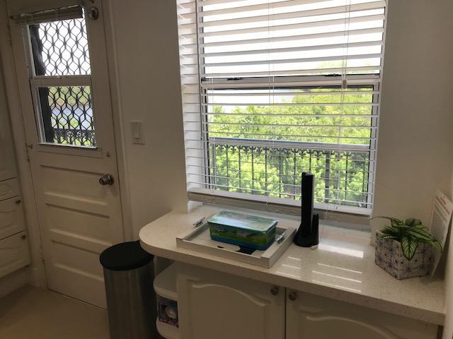 2871 North Ocean Boulevard, Unit V457 Boca Raton, FL 33431 - Photo 7 of 42 a kitchen with a sink and next to a window