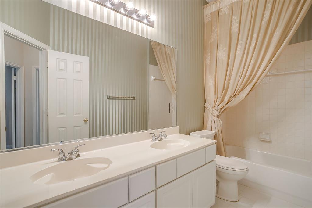 8105 Hosta Way Fort Worth, TX 76123 - Photo 18 of 33 a bathroom with a granite countertop sink toilet and shower