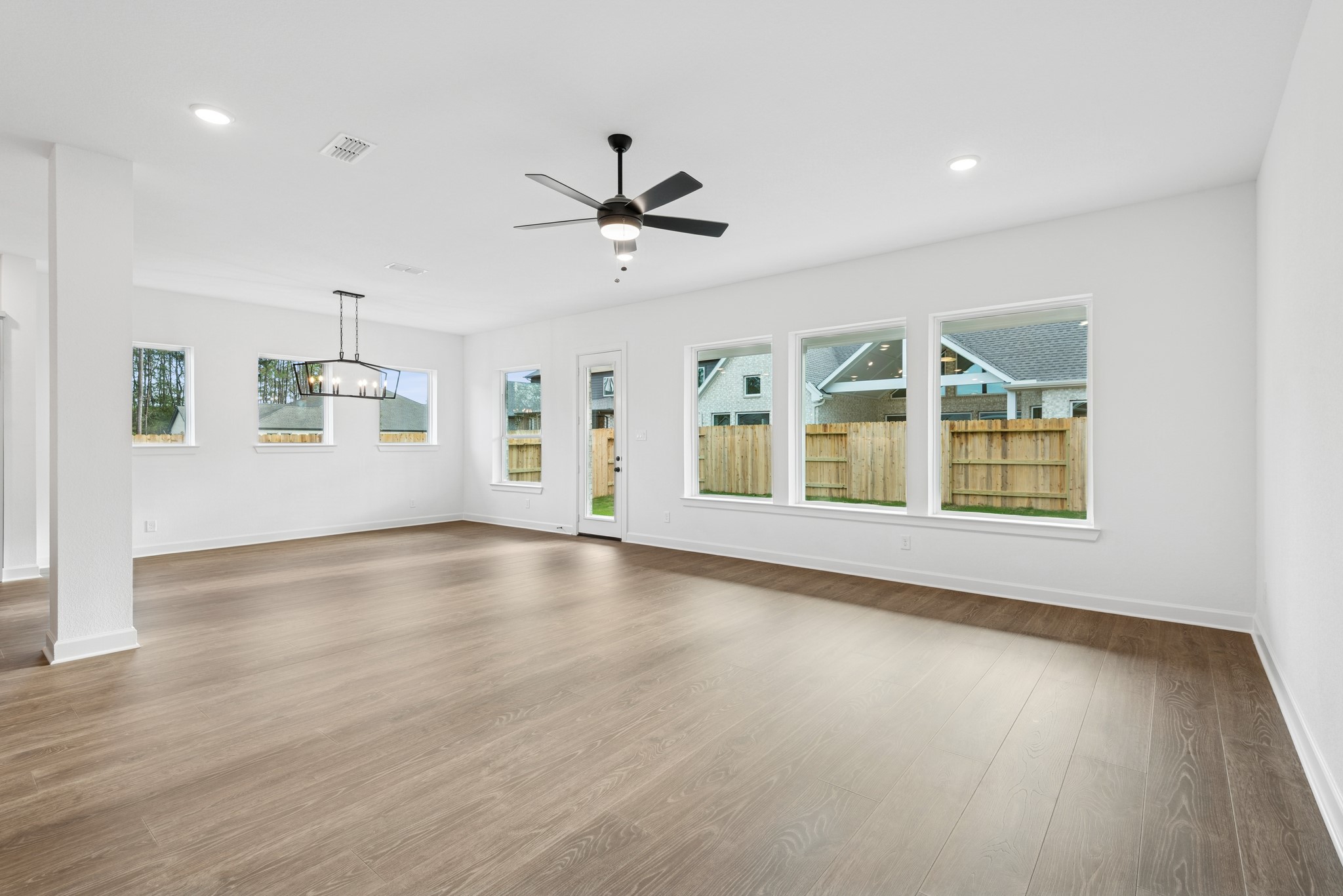 15714 Terracotta Terrace Lane Conroe, TX 77302 - Photo 29 of 47 a view of an empty room with window and wooden floor