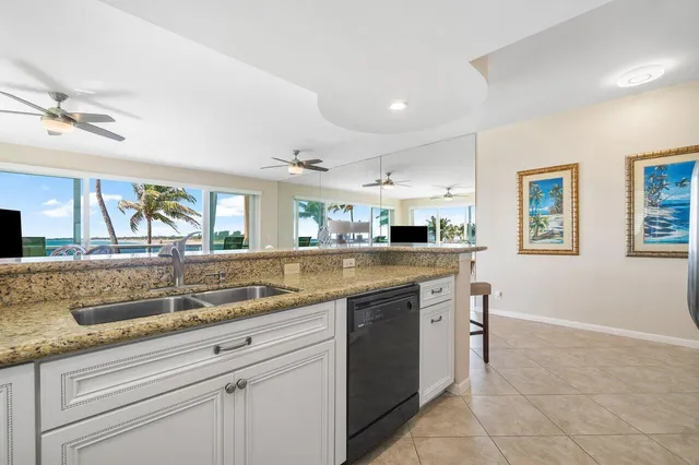 a kitchen with granite countertop a sink and a stove