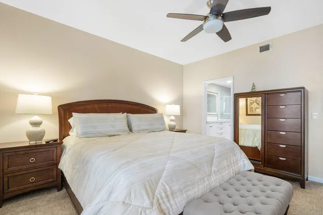 a bedroom with a bed and a night stand