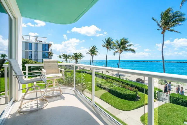 a view of a swimming pool with a chair and tables