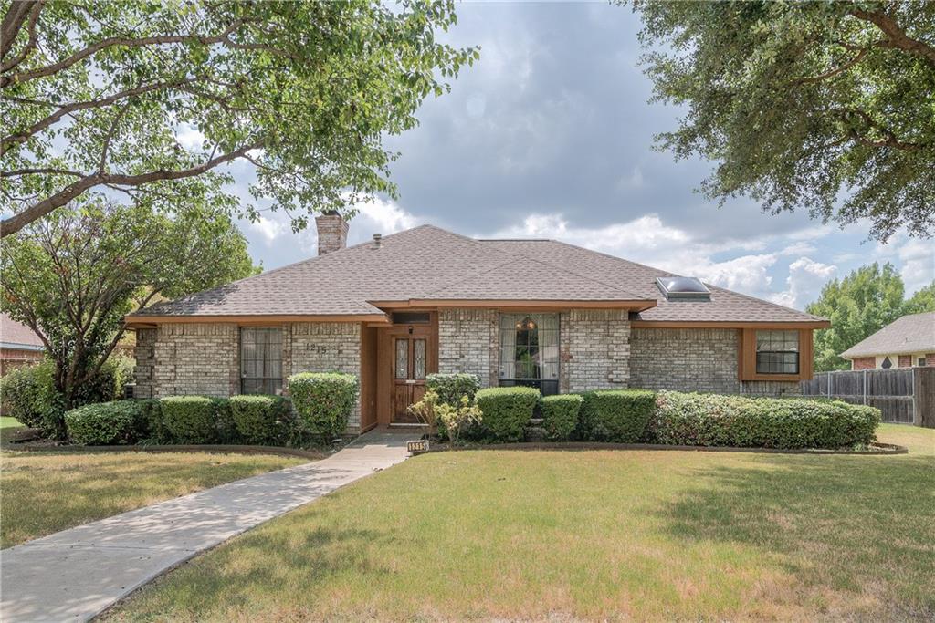 1215 Shawnee Trail Carrollton, TX 75007 - Photo 1 of 1 a front view of a house with a garden