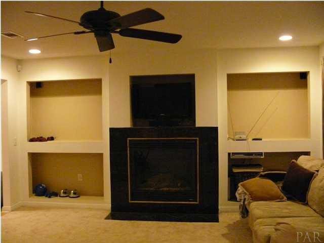 5571 Berryhill Road Milton, FL 32570 - Photo 4 of 10 built in entertainment center with book shelves on both sides of fireplace
