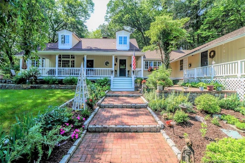 1 New Bridge Road Brookfield, CT 06804 - Photo 1 of 1 a front view of a house with a yard and potted plants
