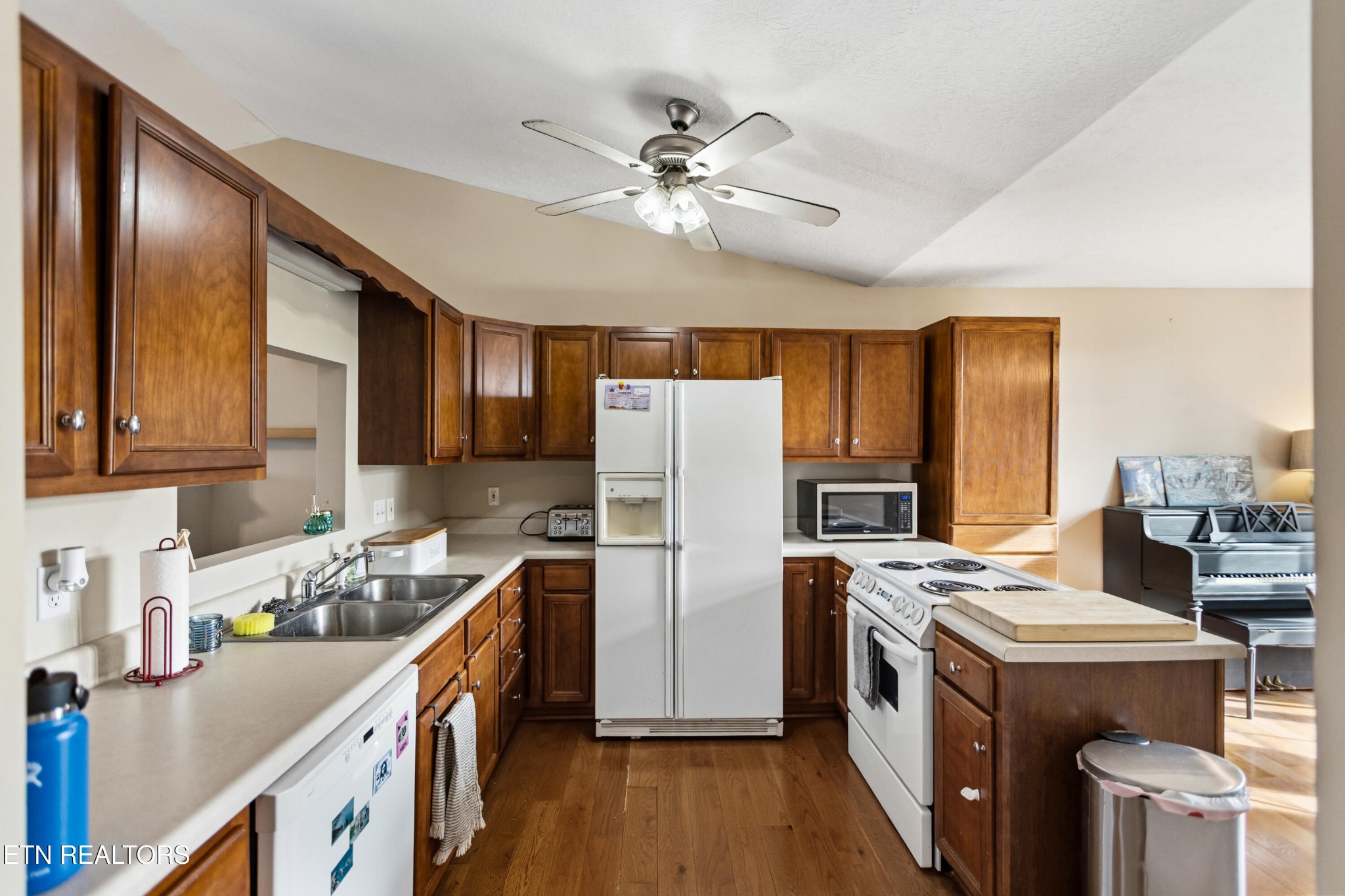 450 Emerts View Circle Seymour, TN 37865 - Photo 8 of 27 a kitchen with stainless steel appliances a stove a refrigerator a sink dishwasher and wooden cabinets with wooden floor