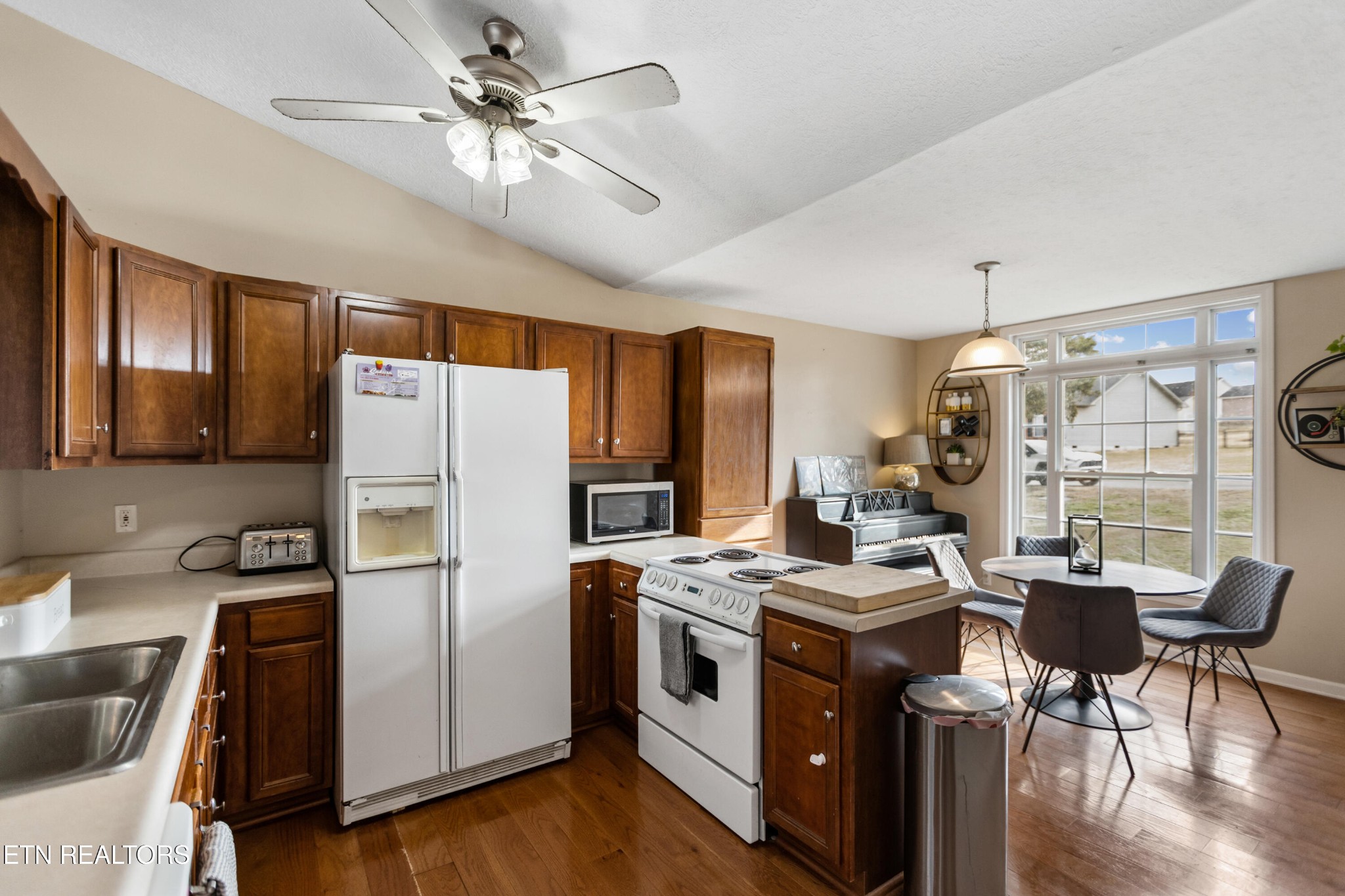 450 Emerts View Circle Seymour, TN 37865 - Photo 10 of 27 a kitchen with stainless steel appliances a stove a refrigerator a sink a dining table and chairs