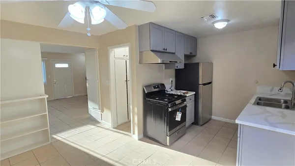 a kitchen with stainless steel appliances granite countertop a refrigerator and a stove
