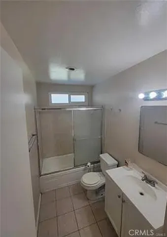 a bathroom with a double vanity sink toilet and shower