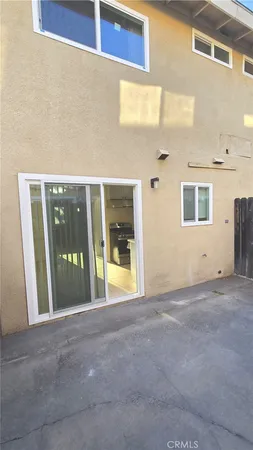 a view of an empty room with entrance and door