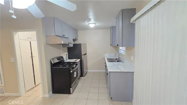 a kitchen with a stove and a refrigerator