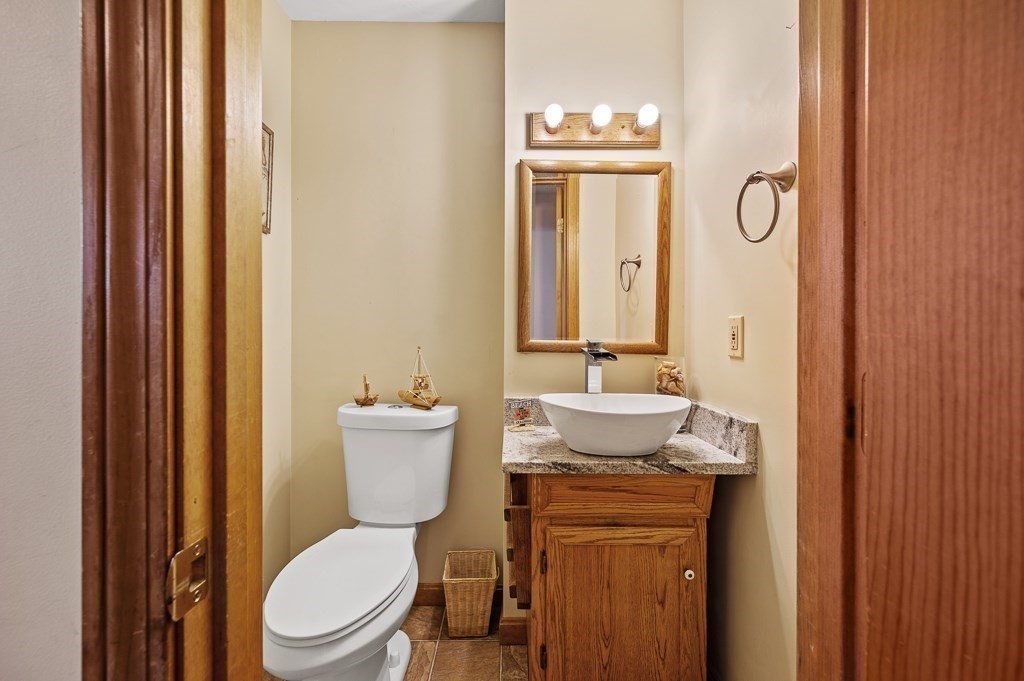 8 Hyde Street Worcester, MA 01606 - Photo 13 of 36 a bathroom with a toilet a sink and mirror