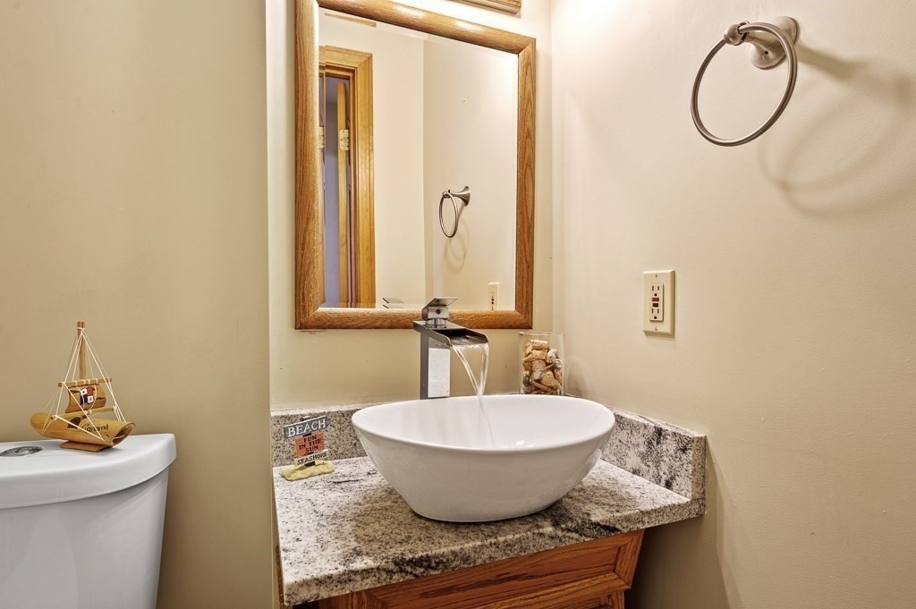 8 Hyde Street Worcester, MA 01606 - Photo 14 of 36 a bathroom with a granite countertop sink and a mirror