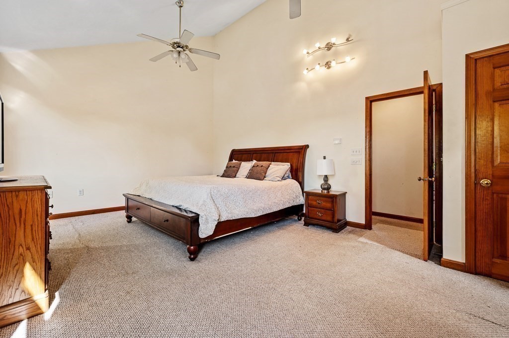 8 Hyde Street Worcester, MA 01606 - Photo 15 of 36 a bedroom with a bed and a chandelier