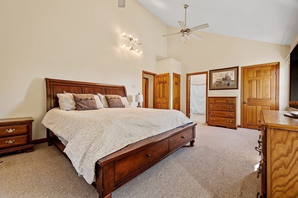 8 Hyde Street Worcester, MA 01606 - Photo 16 of 36 a spacious bedroom with a bed and a chandelier