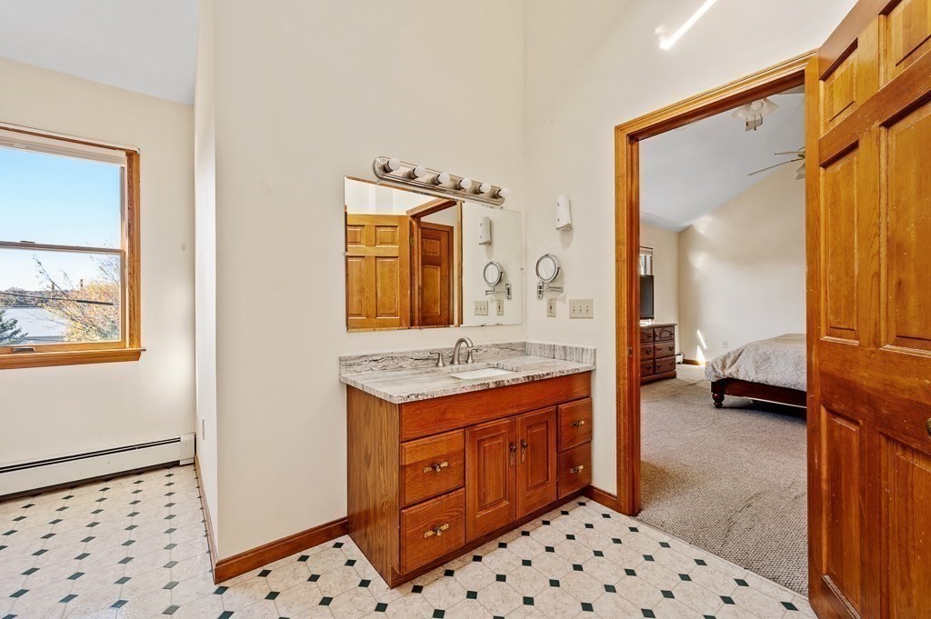 8 Hyde Street Worcester, MA 01606 - Photo 18 of 36 a en suite bathroom with a granite countertop sink and a mirror