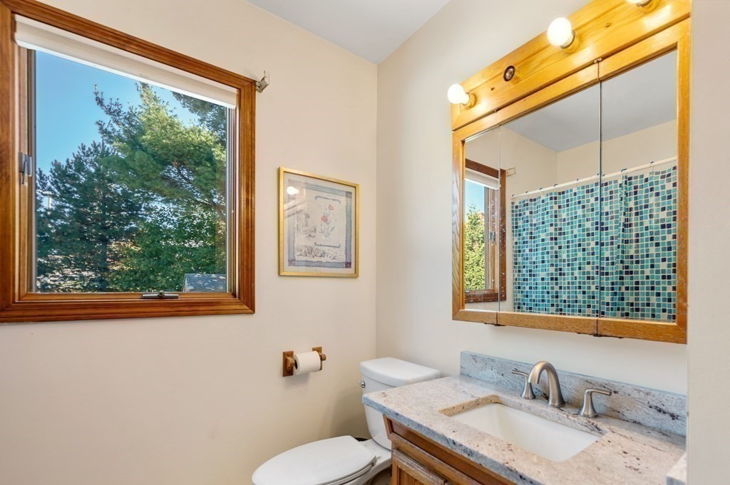 8 Hyde Street Worcester, MA 01606 - Photo 21 of 36 a bathroom with a granite countertop sink mirror vanity and toilet