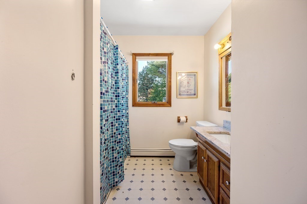 8 Hyde Street Worcester, MA 01606 - Photo 22 of 36 a bathroom with a sink a toilet a window and a shower