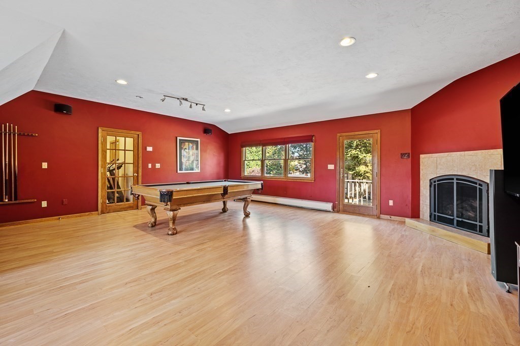 8 Hyde Street Worcester, MA 01606 - Photo 27 of 36 a living room with furniture pool table wooden floor and a fireplace