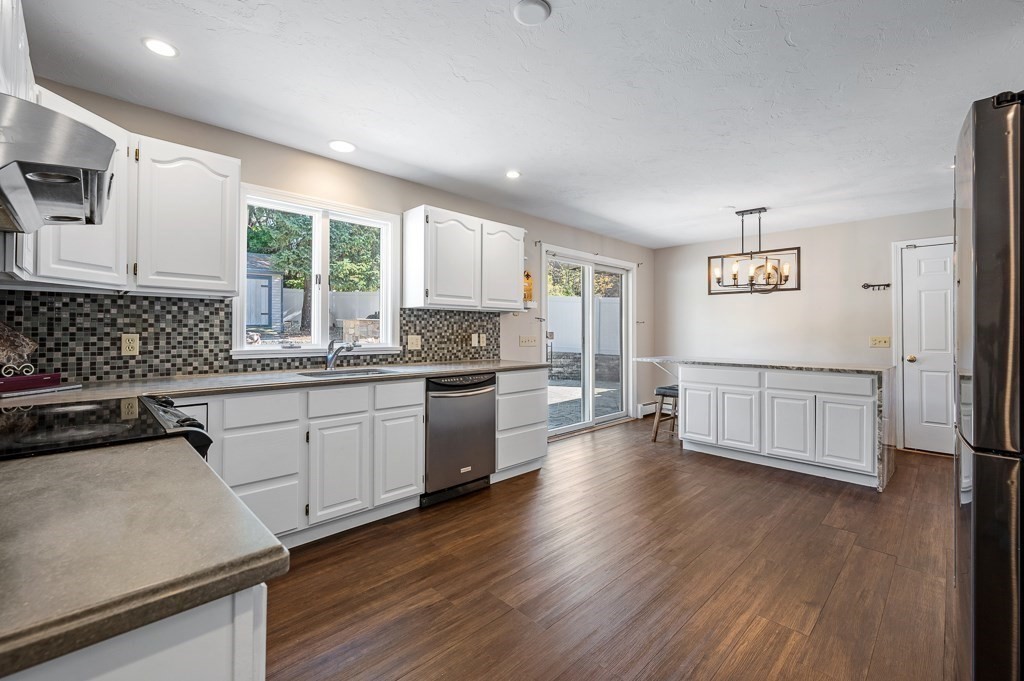 8 Hyde Street Worcester, MA 01606 - Photo 6 of 36 a kitchen with granite countertop white cabinets and white appliances