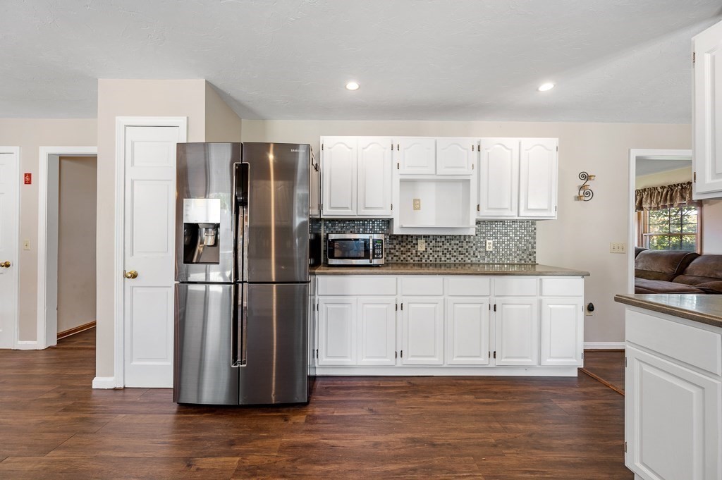 8 Hyde Street Worcester, MA 01606 - Photo 7 of 36 a kitchen with a refrigerator and white cabinets