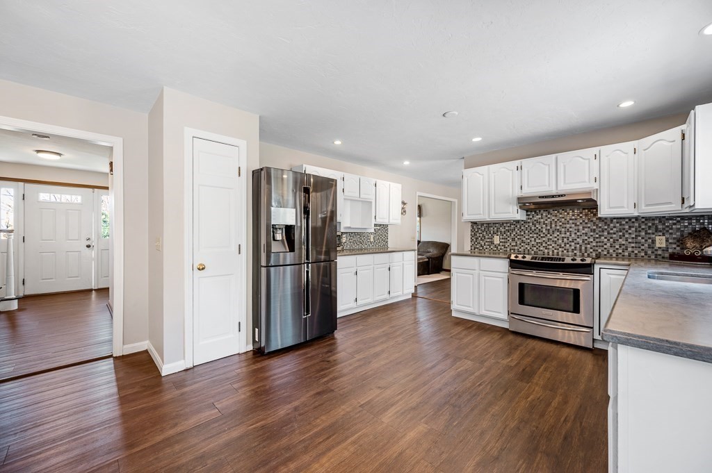 8 Hyde Street Worcester, MA 01606 - Photo 9 of 36 a kitchen with stainless steel appliances granite countertop a refrigerator and a stove top oven